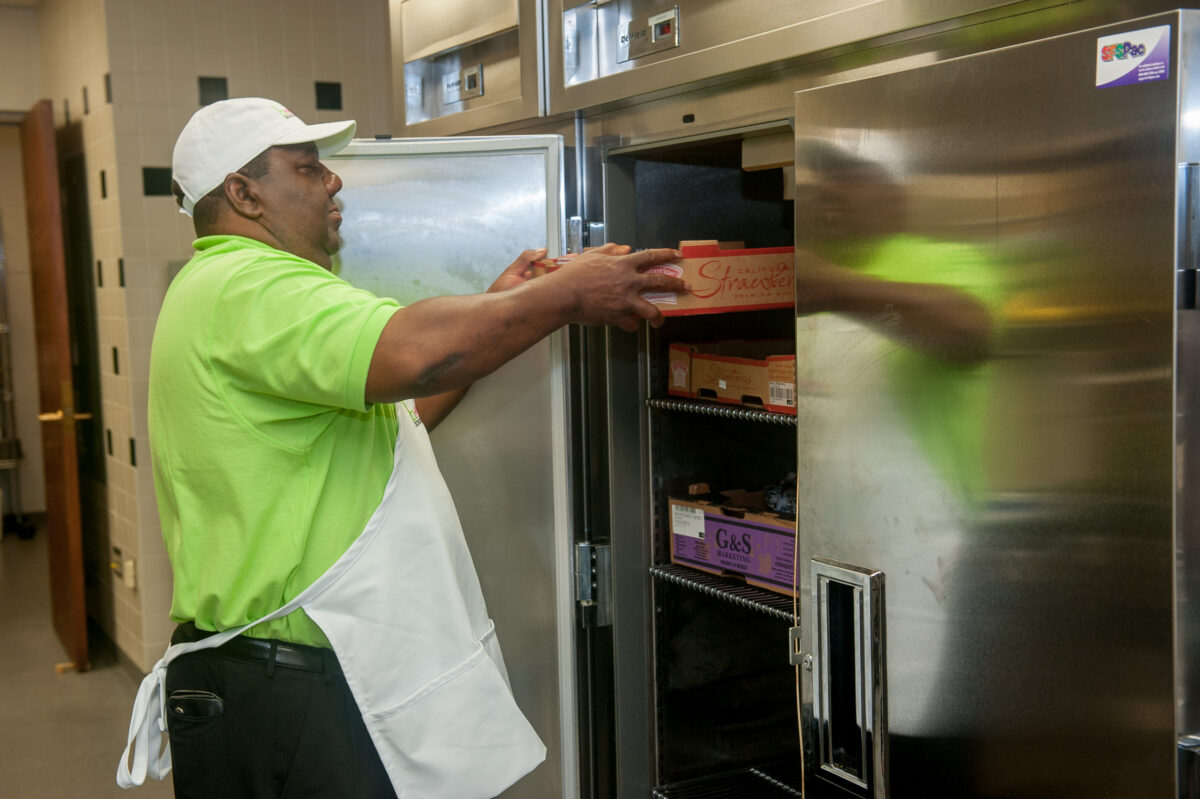 man getting food out of the refridgerator